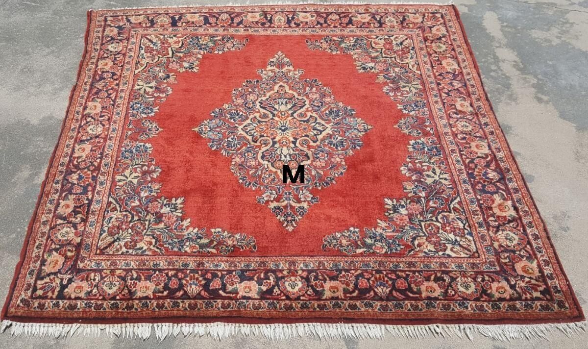 A rug with the letter m on it