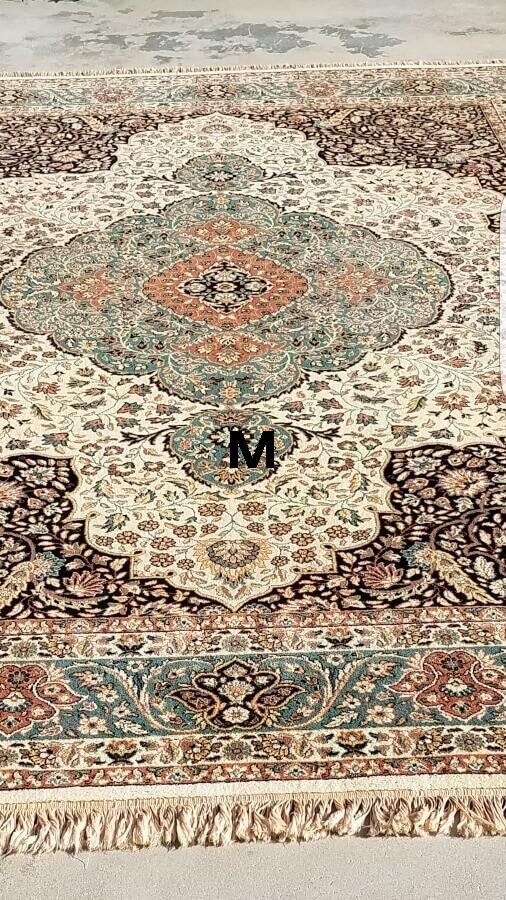 A rug with a monogram on it is sitting on the floor.
