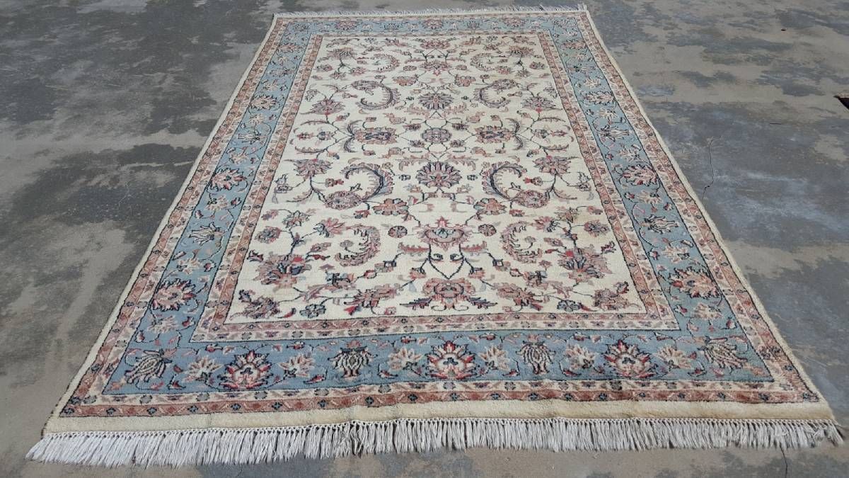 A rug with a floral pattern is sitting on the ground.