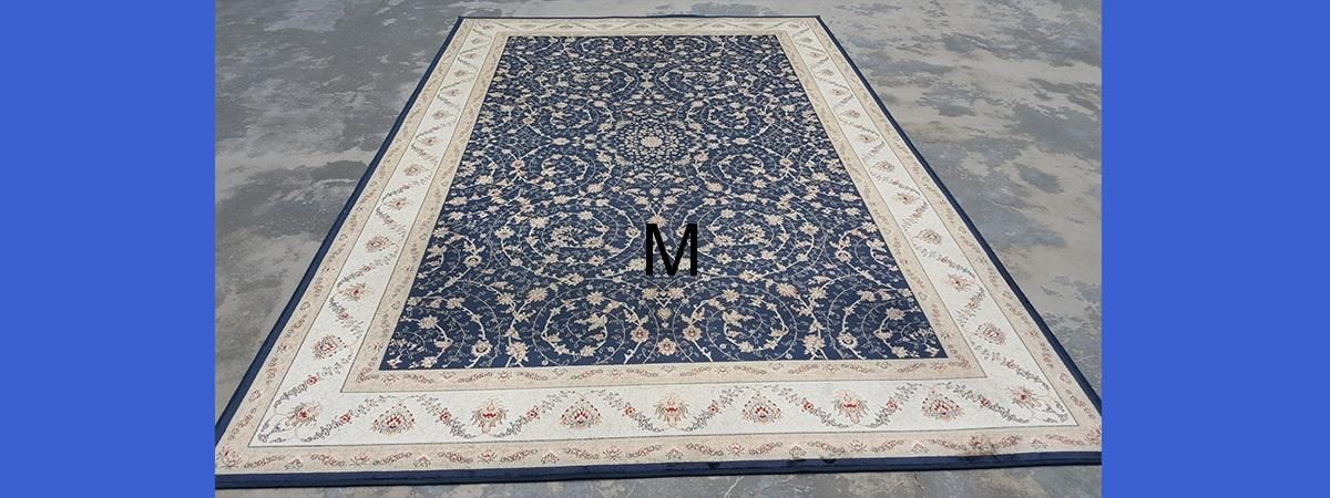 A black and white rug is sitting on a concrete floor.