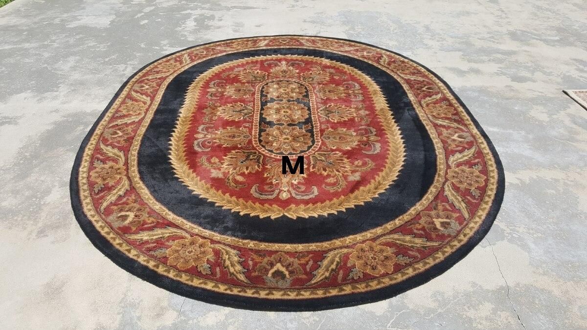 A round rug with the letter m on it