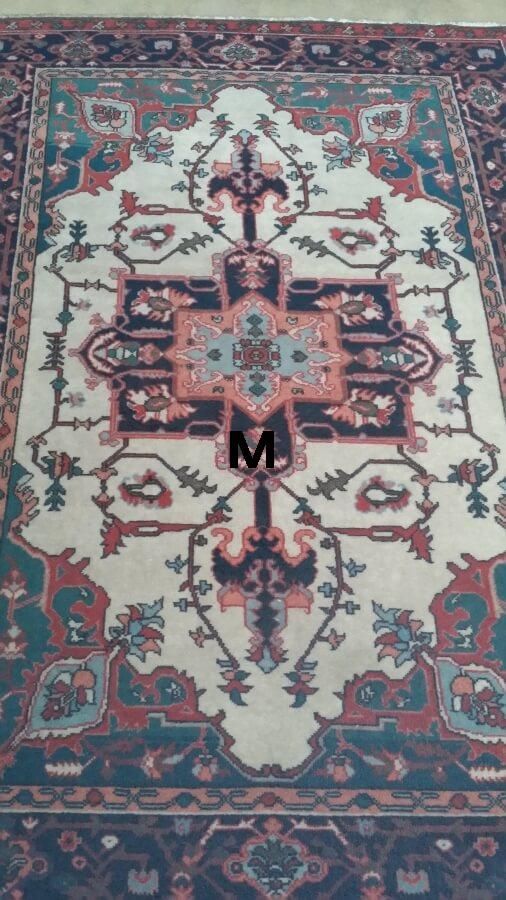 A rug with the letter m on it