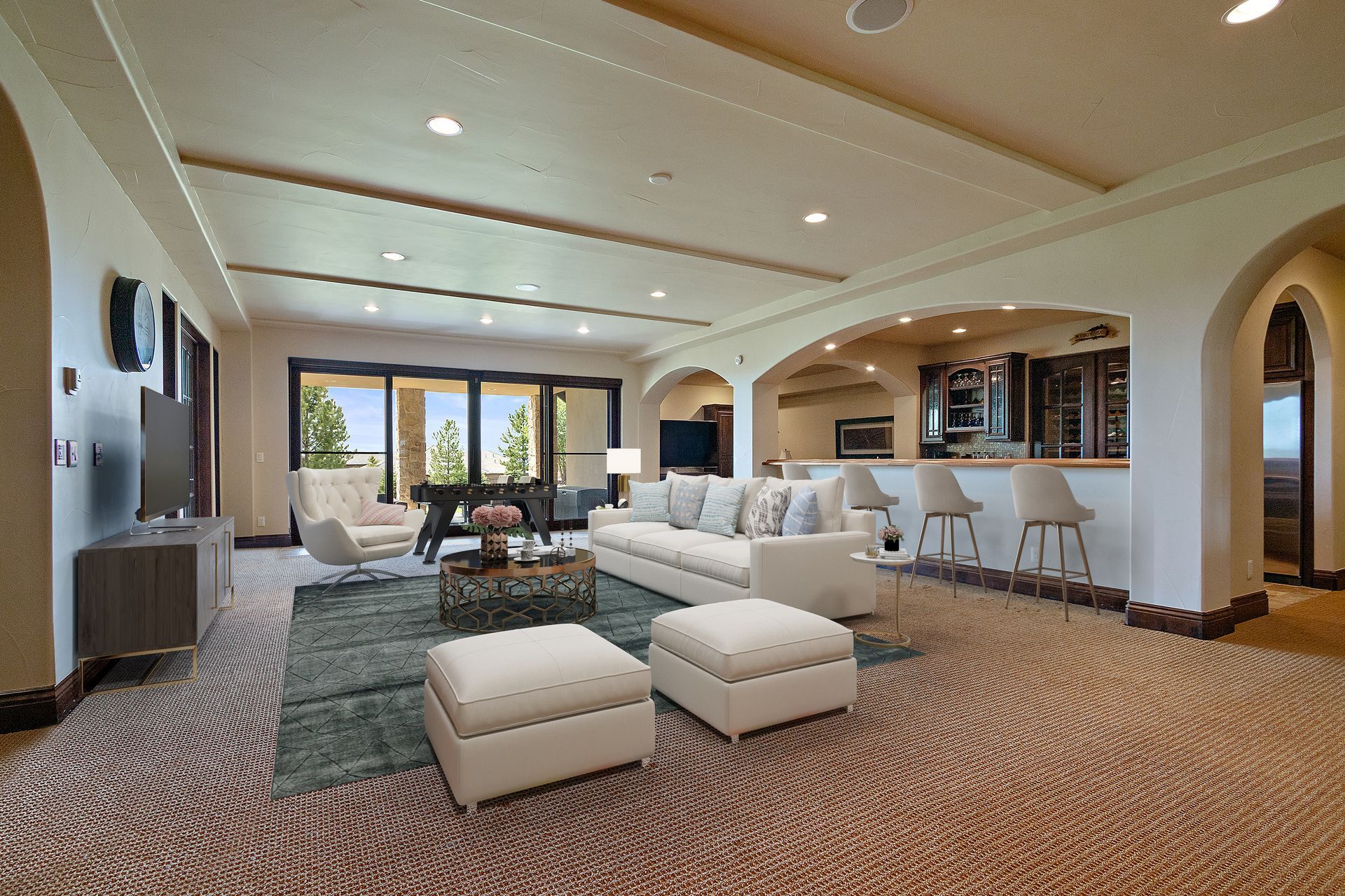 Spacious living room with a bar area, a large couch, and sliding glass doors.