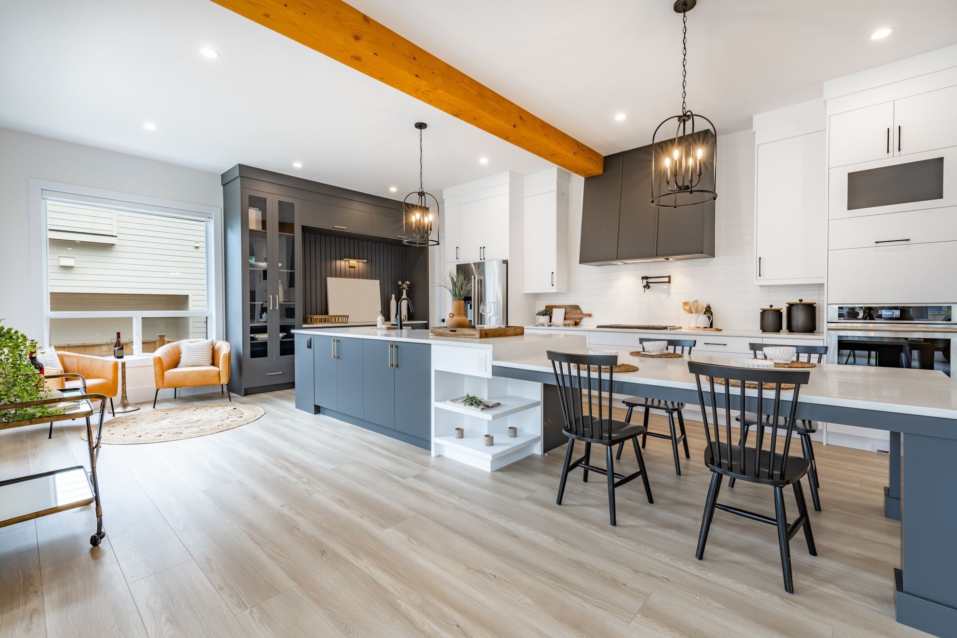 A large kitchen with a dining table and chairs in it.