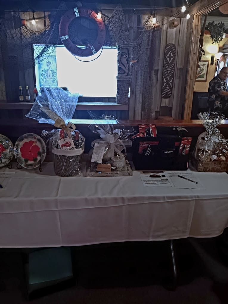 A table with baskets and plates on it in front of a television.