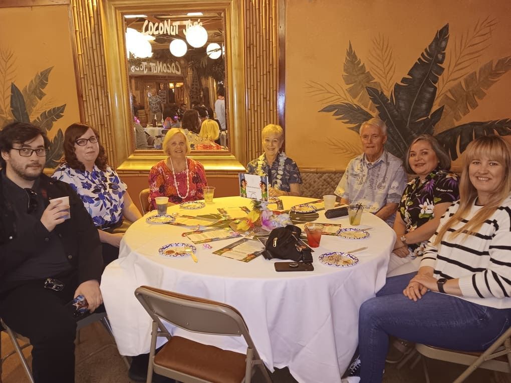 A group of people are sitting around a table in a room.