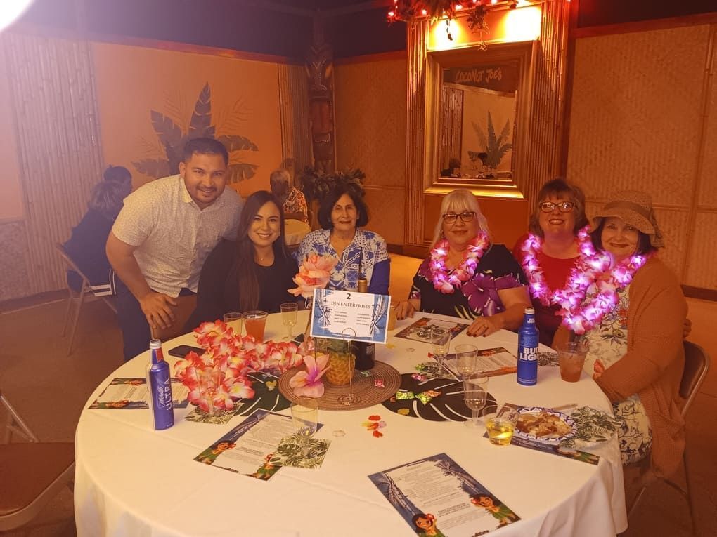 A group of people are posing for a picture at a table.