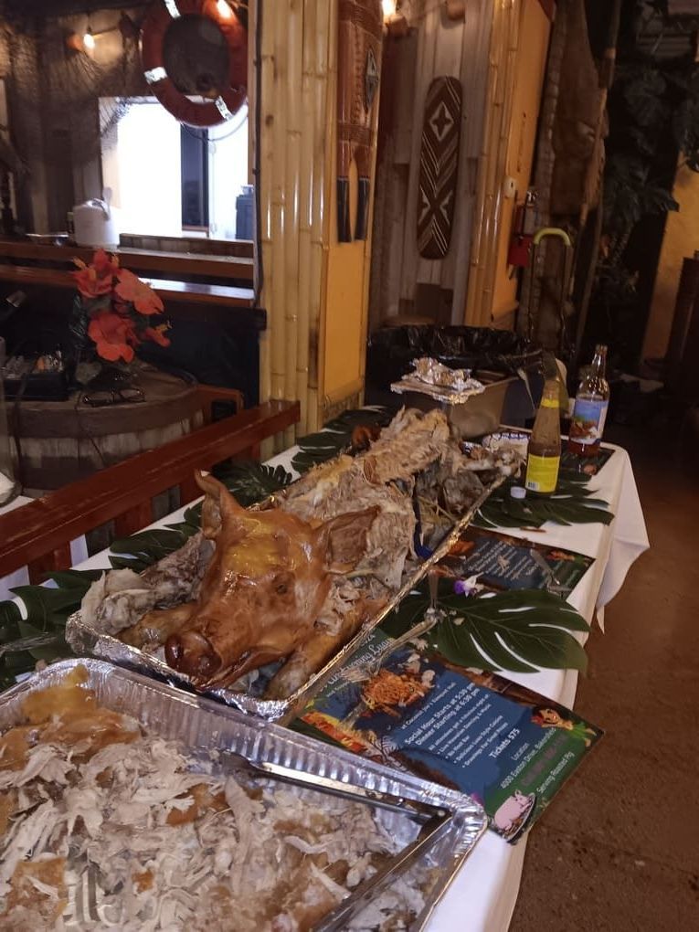 A table with what's left of a roasted pig