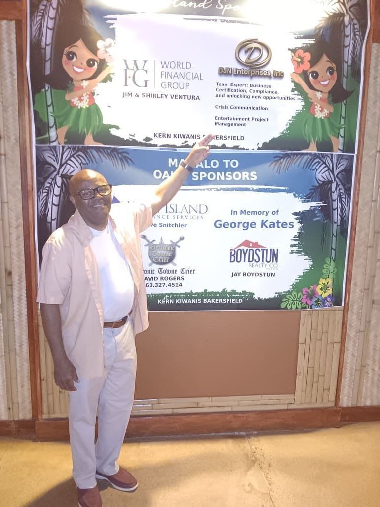 A man standing in front of a sign that says mc also to dj sponsors