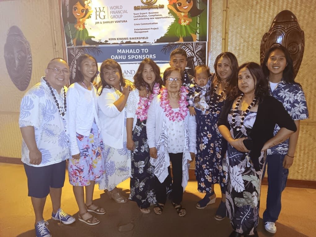 A group of people standing in front of a sign that says manalo to dohu sponsors