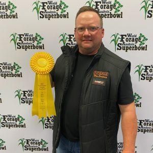 Man in vest holding a yellow ribbon at the 