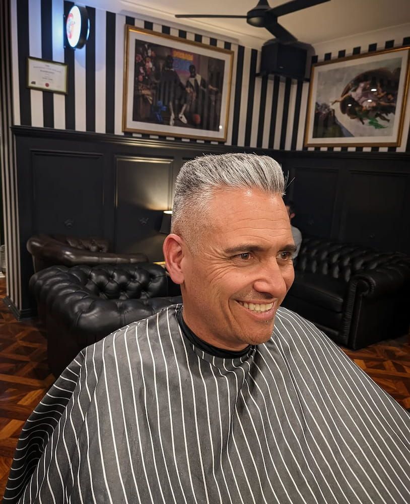 A Man is Getting His Hair Cut at a Barber Shop — Connolly & Co Barbers In Robina, QLD