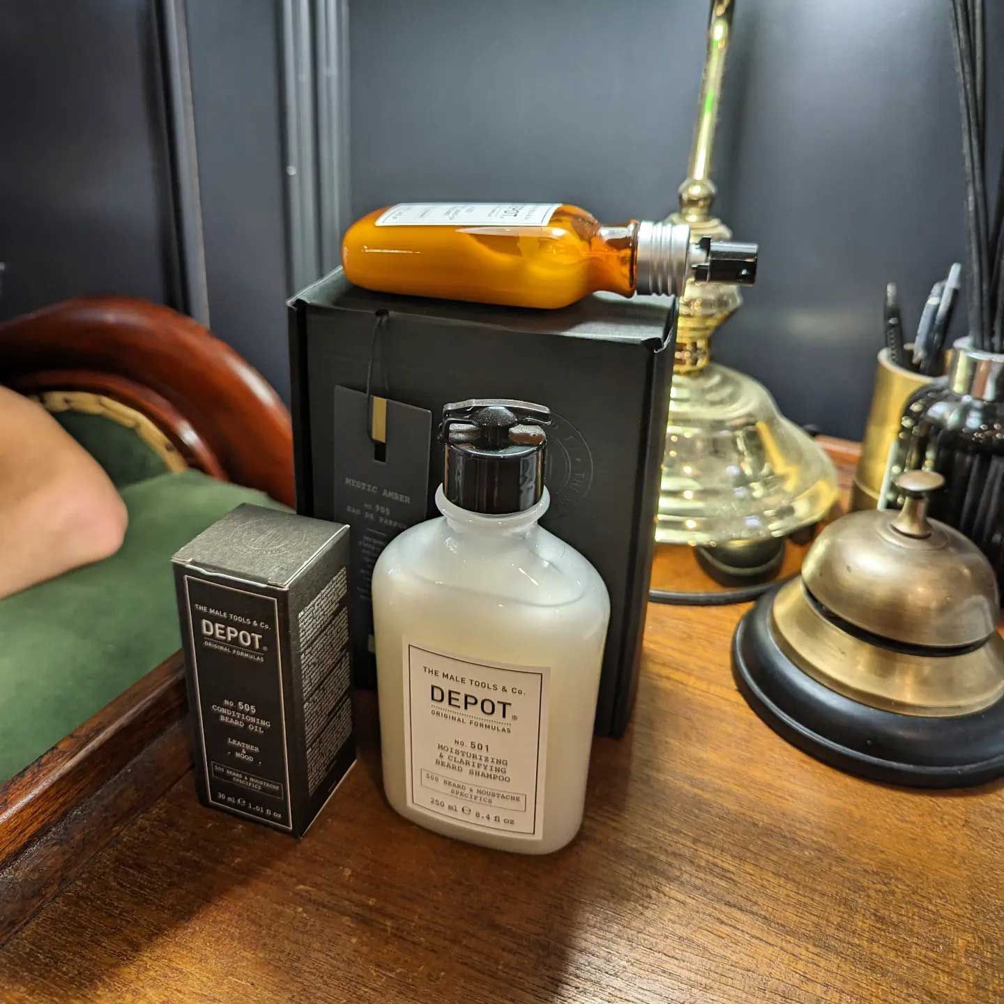 A Bottle Of Depot Lotion Sits On A Wooden Table — Connolly & Co Barbers in Robina, QLD
