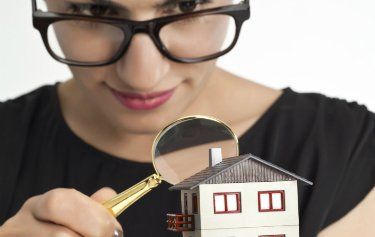 women checking the house with magnifying glass