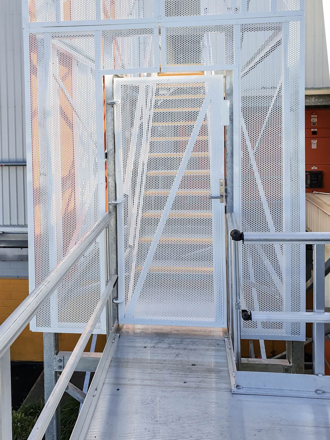 secure access with a custom made caged door and stairs to stair tower installed at cold storage facility 