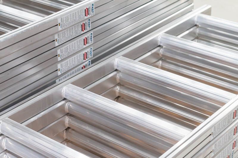 aluminium ladders piled up 