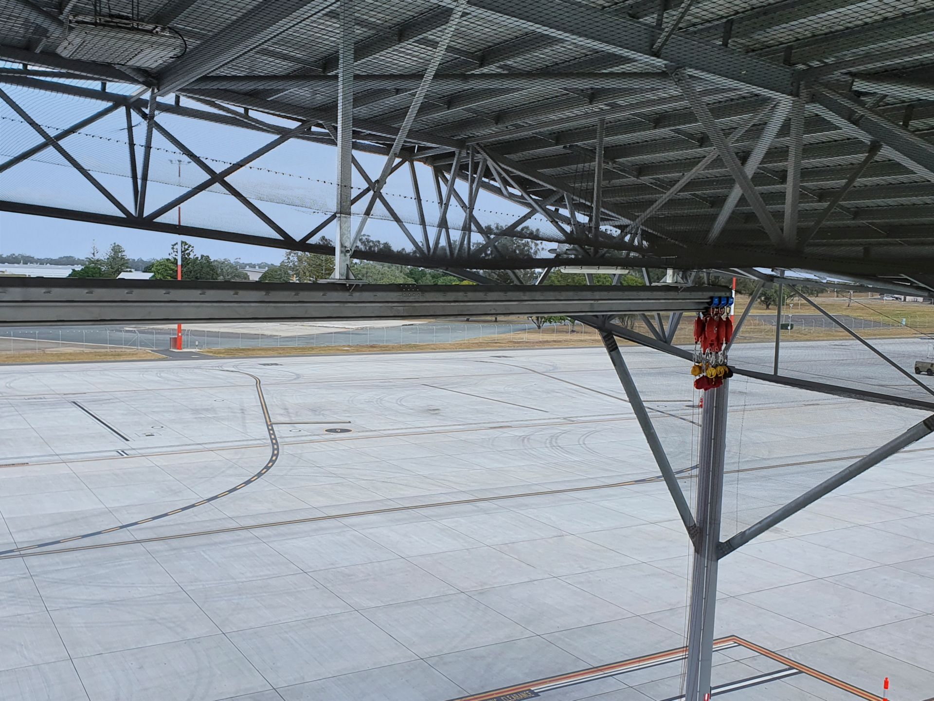 Overhead rail systems mounted to aircraft hangar ceiling