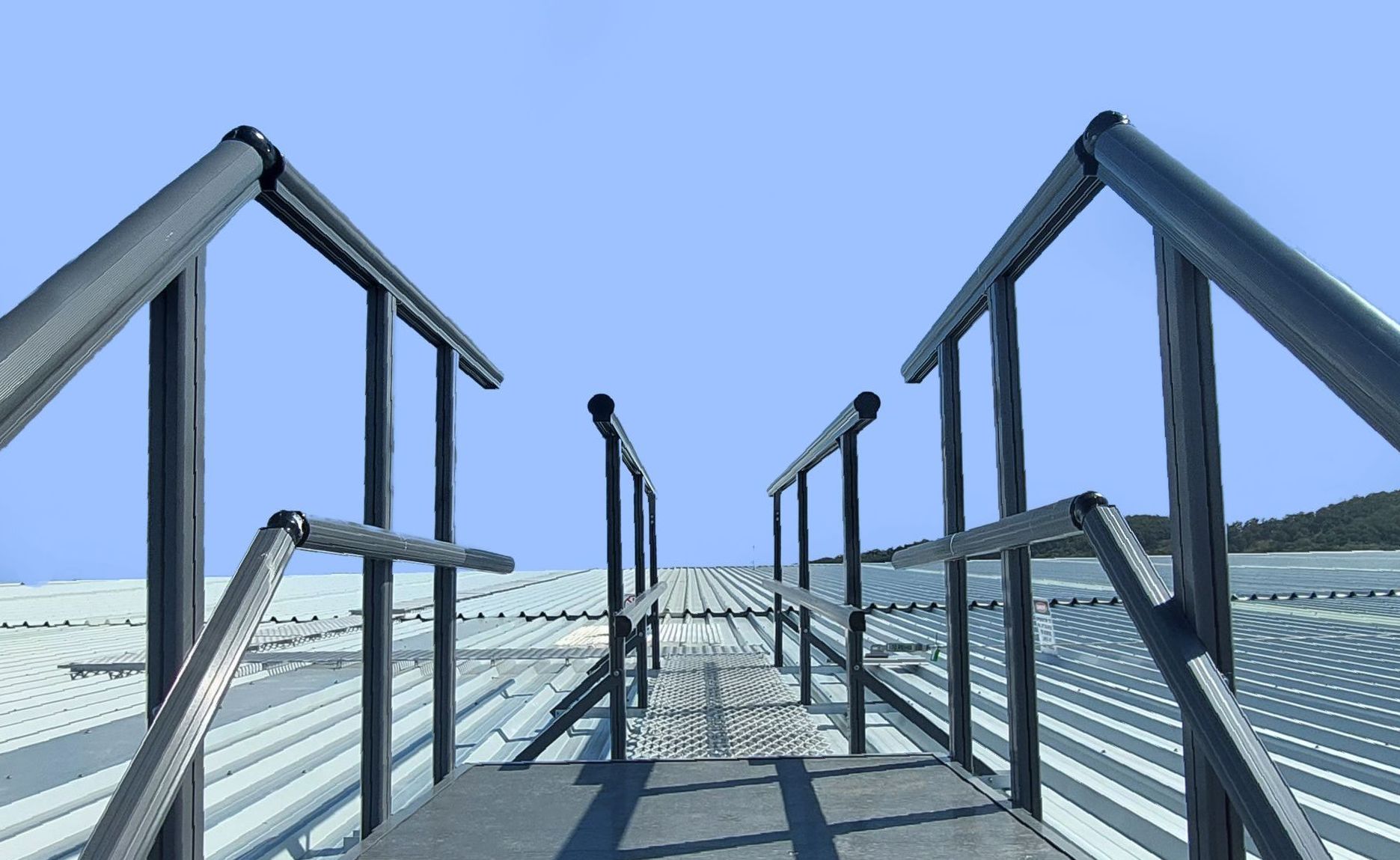 Image of a roof access system including mesh walkway, aluminium guardrail, access platform and access ladder.