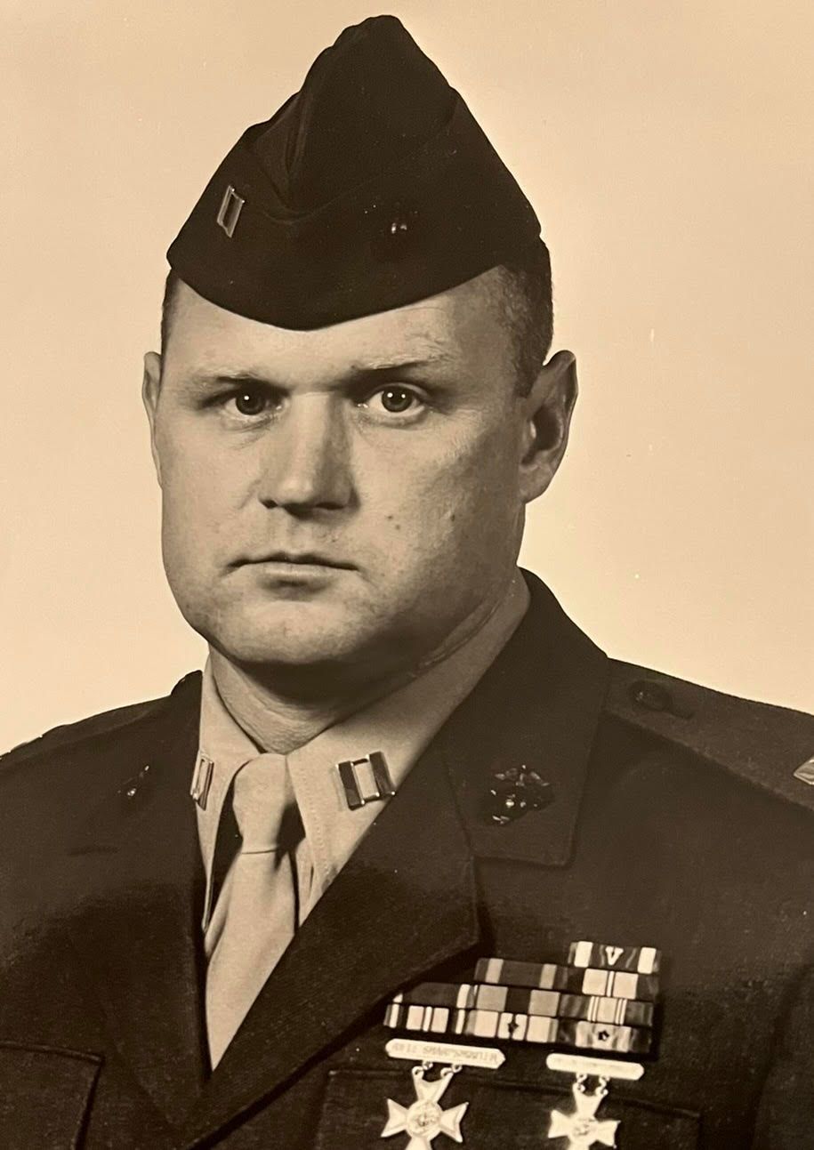 A black and white photo of a man in a military uniform