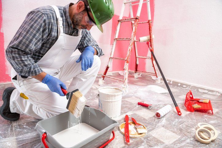 House painter worker at work in the construction site