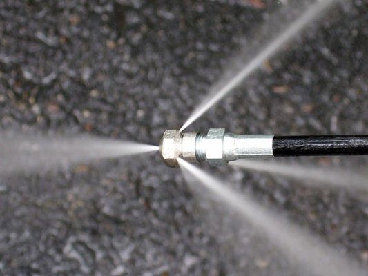 Pressure washer nozzle spraying water.