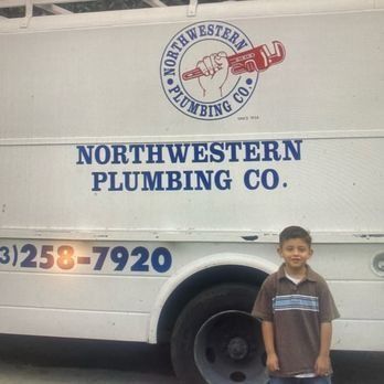 A boy stands near a white plumbing truck with the company's logo and phone number.