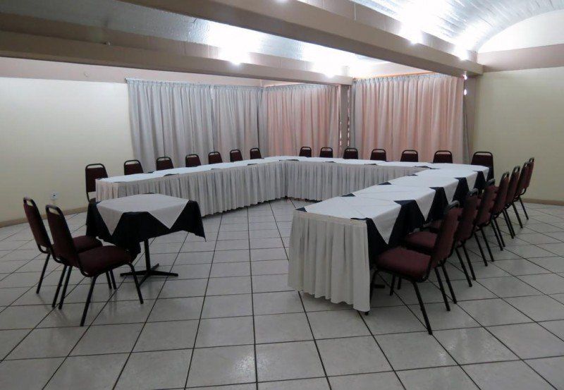 sala de reunião com mesas dispostas em formato U