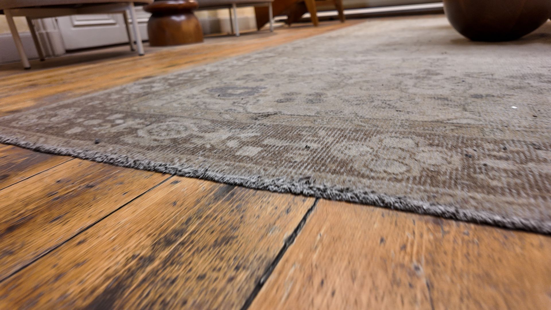 Close-up view of a dirty rug on wooden floor. Close-up view of a dirty rug on wooden floor.