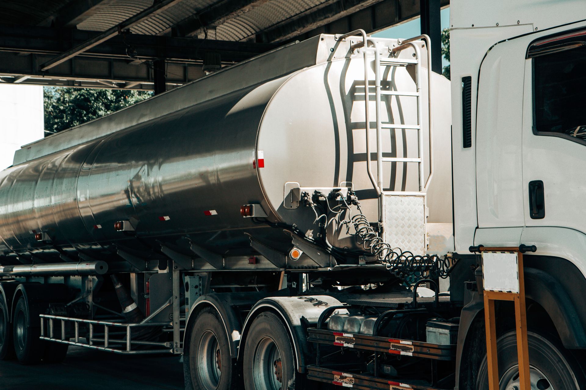 Construction site silhouetted against a sunlit, foggy sky with beams of light.