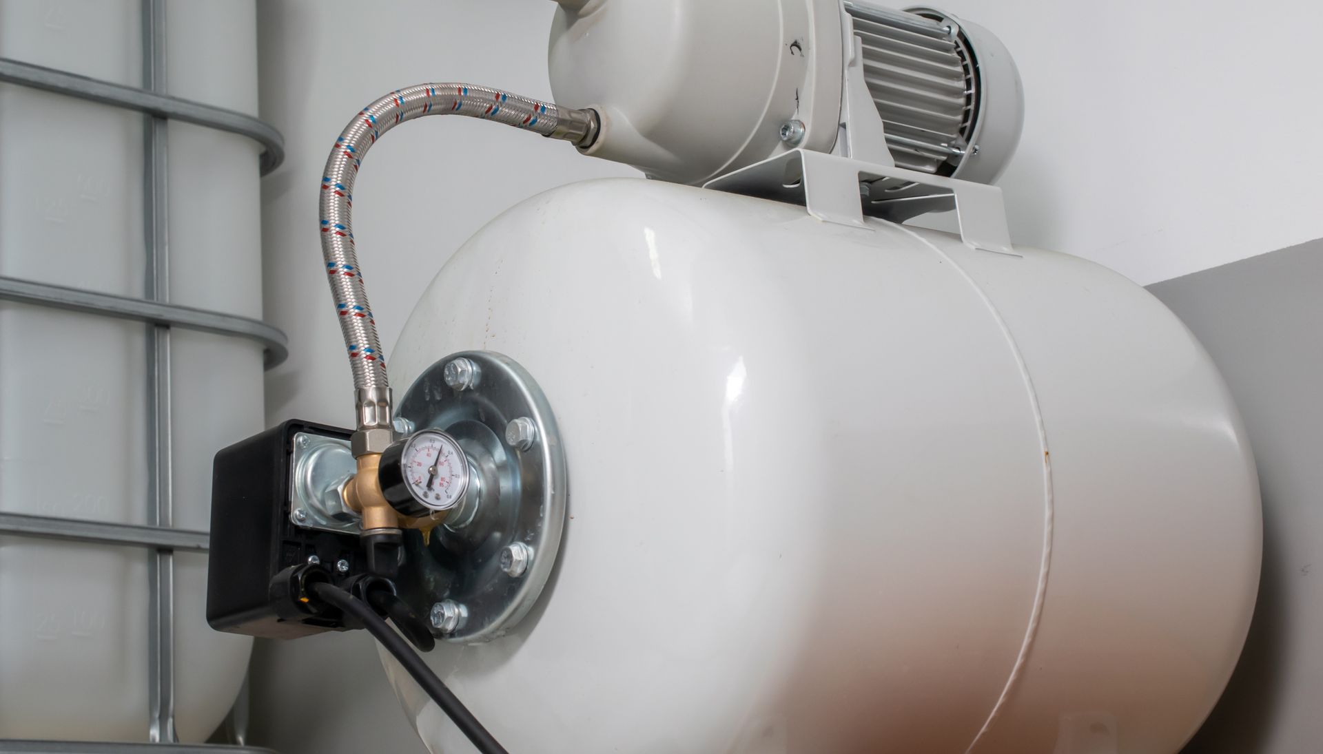 White water pressure tank with attached motor and pressure gauge.
