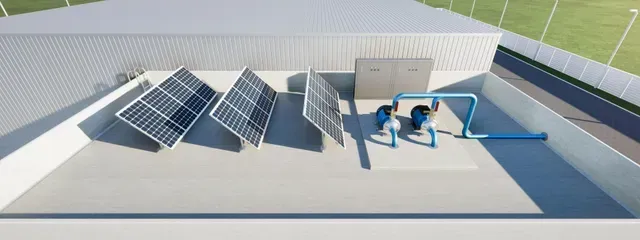 Solar panels and water pipes on a building rooftop.