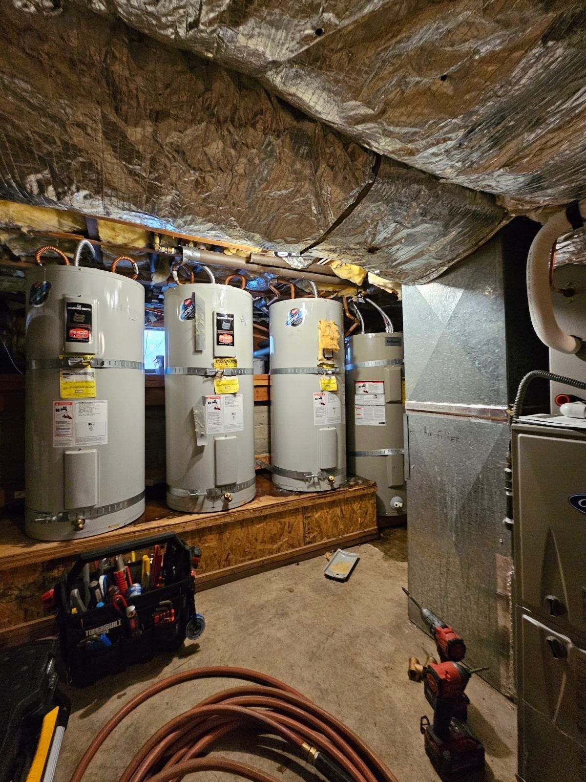 A bunch of water heaters are sitting in a room, Purist Plumbing and Excavation LLC