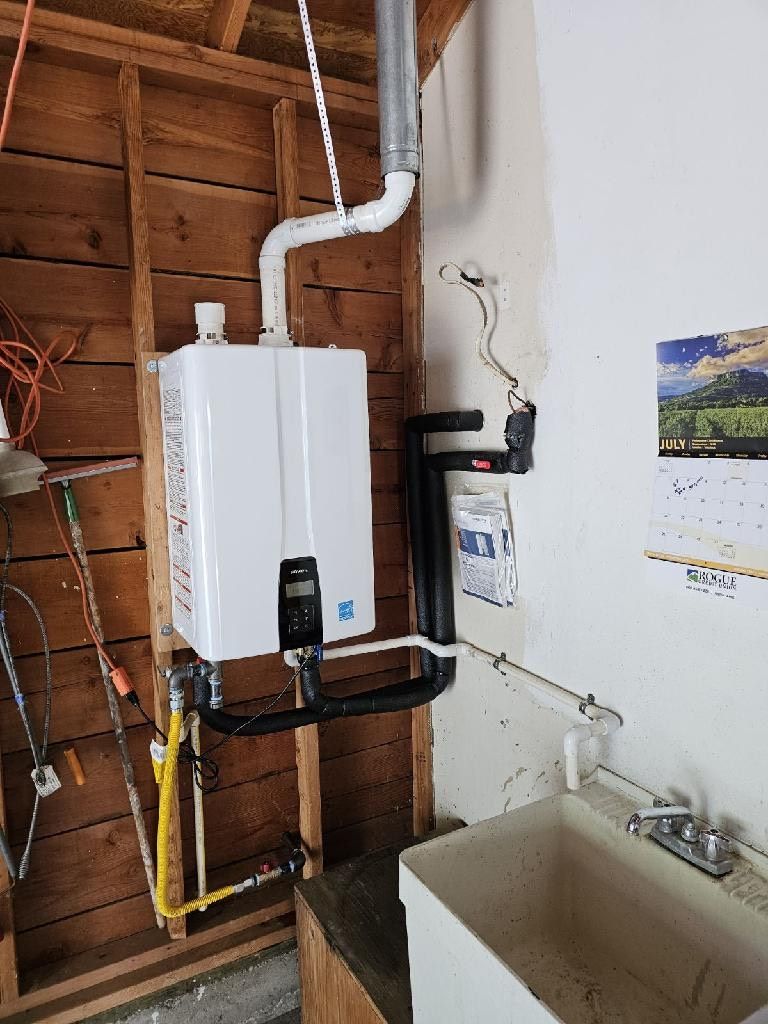 A bathroom with a sink and a heater on the wall.