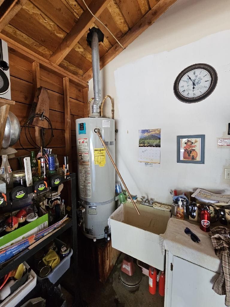 A room with a sink and a clock on the wall, Purist Plumbing and Excavation LLC