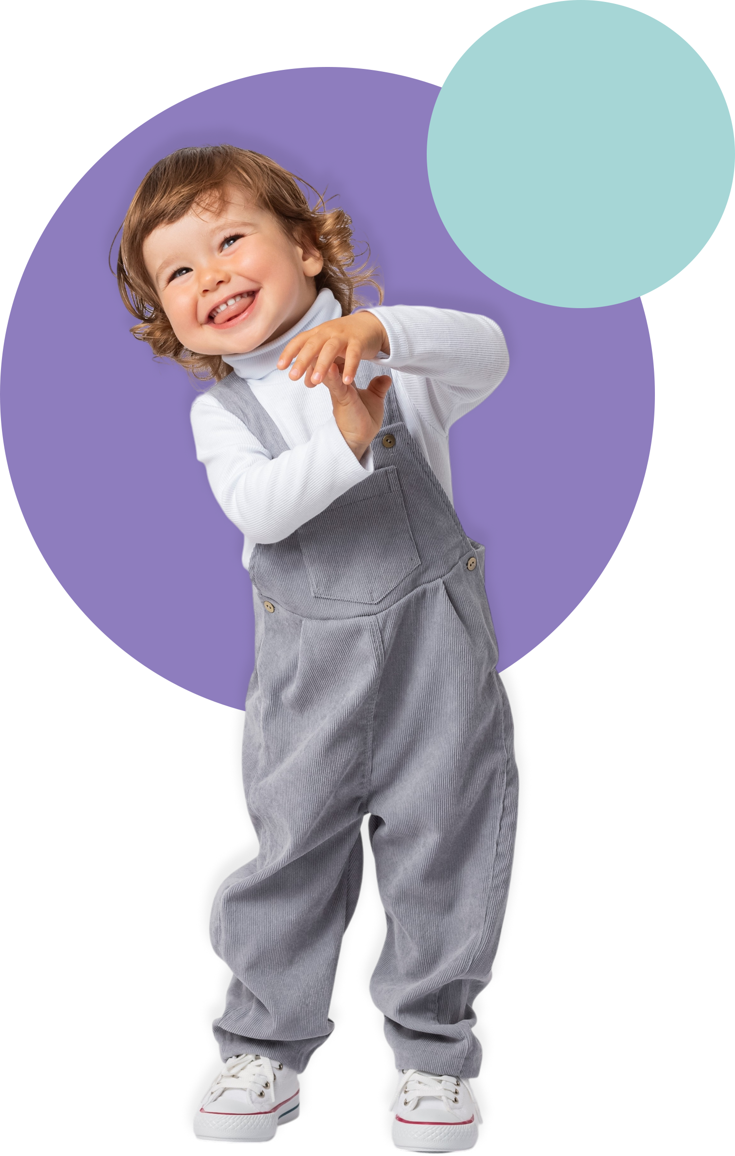 Smiling child in gray overalls and white shirt standing in front of purple and teal circles