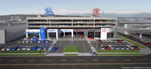 3D architectural model of car dealership building exterior with upper story and surrounding parking including red, blue, silver cars with blue sky
