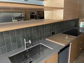 A kitchen with a sink , stove , and dishwasher.