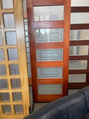 A row of wooden doors with frosted glass