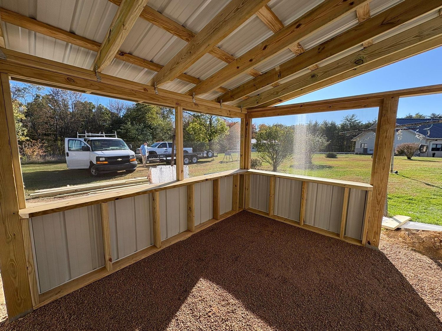A newly built wooden porch in front of a house, blocked off by yellow