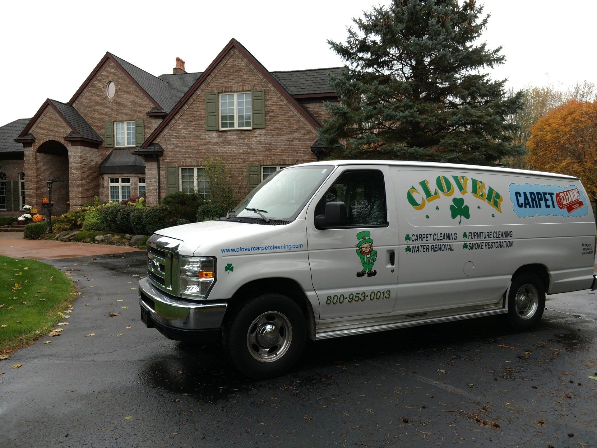 A House Performing Carpet Cleaning Portrait — St. John’s, MI — Clover Carpet Cleaning
