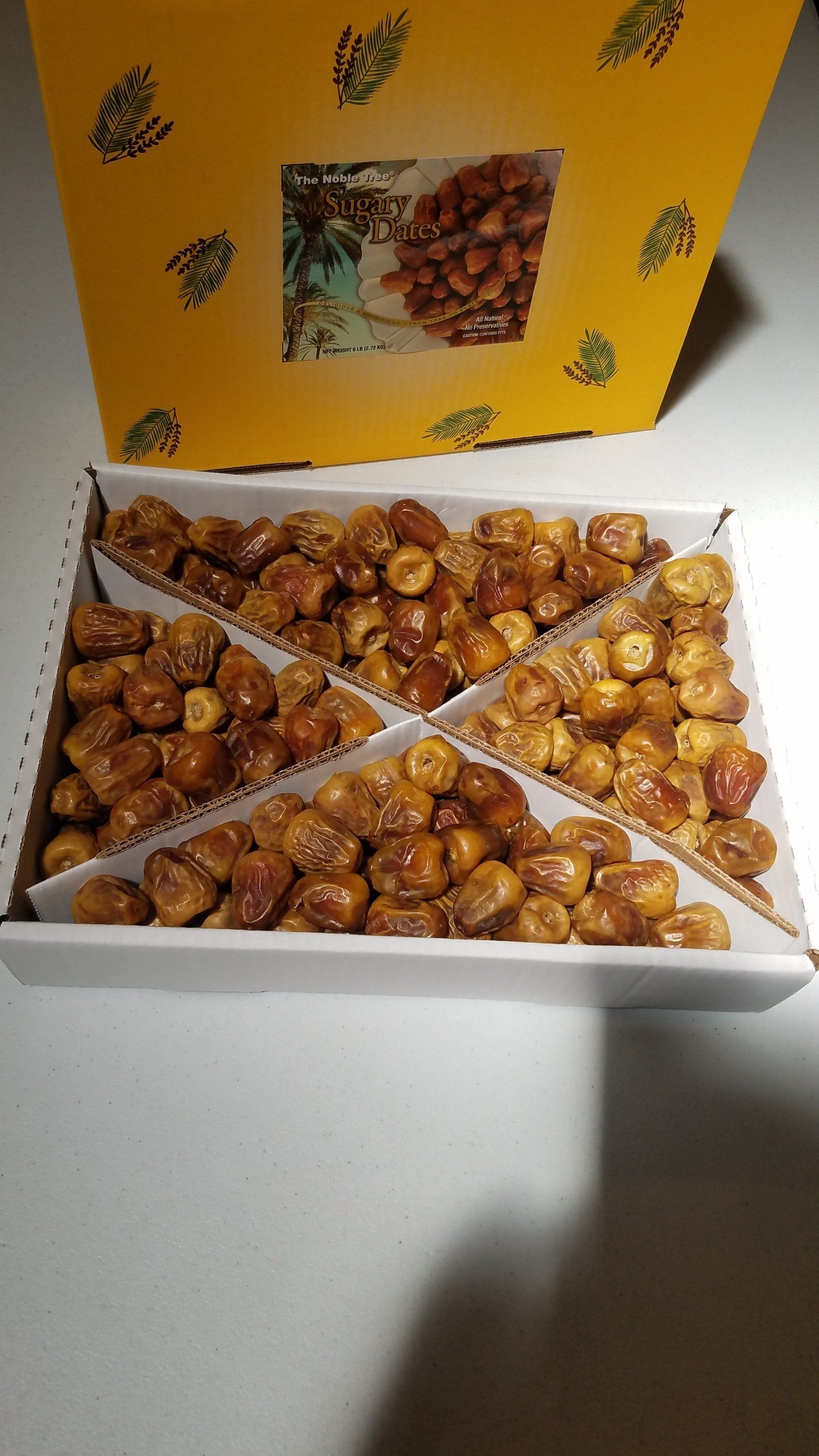 A box filled with nuts is sitting on a table.
