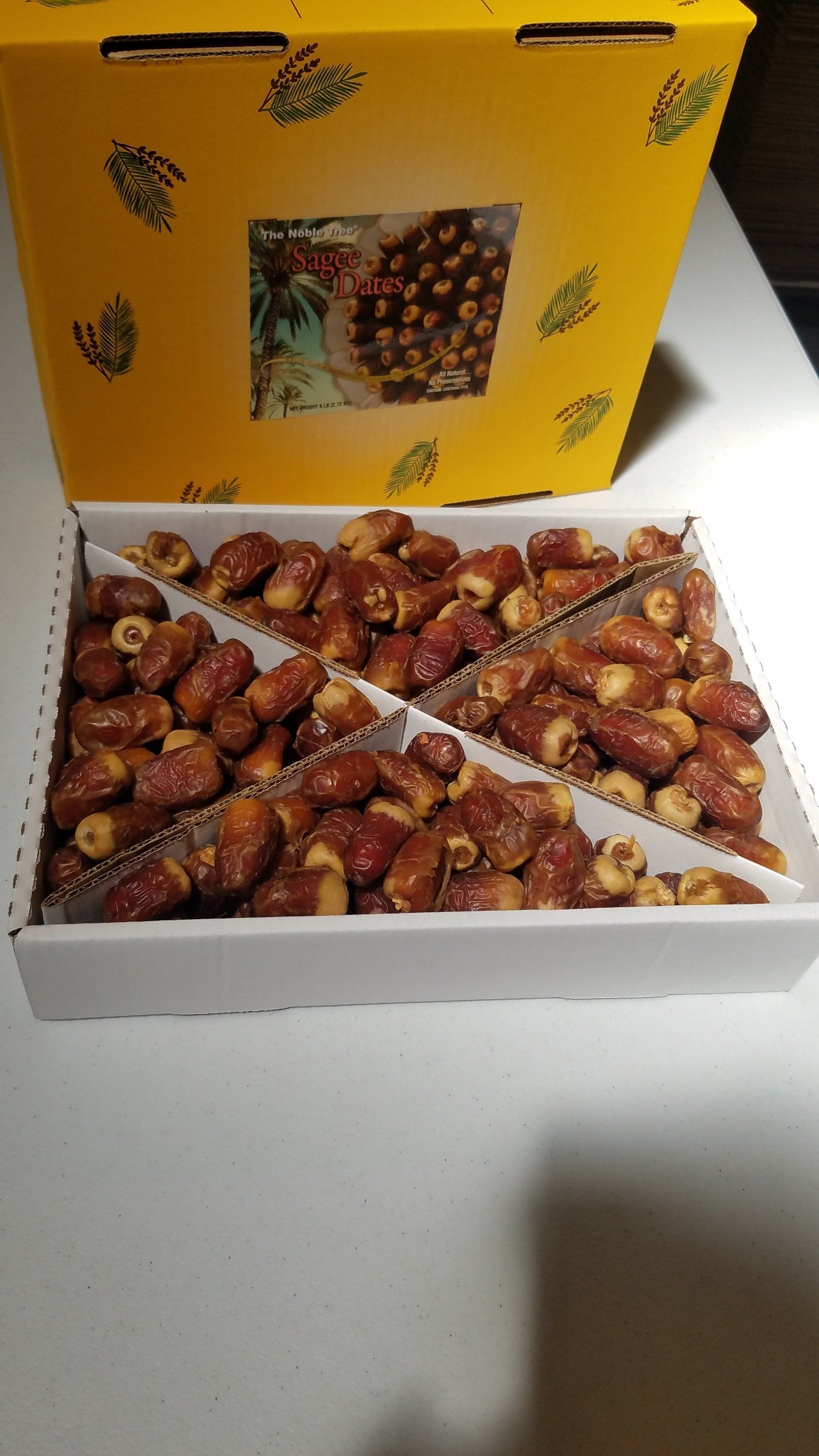 A box of dates is sitting on a table.