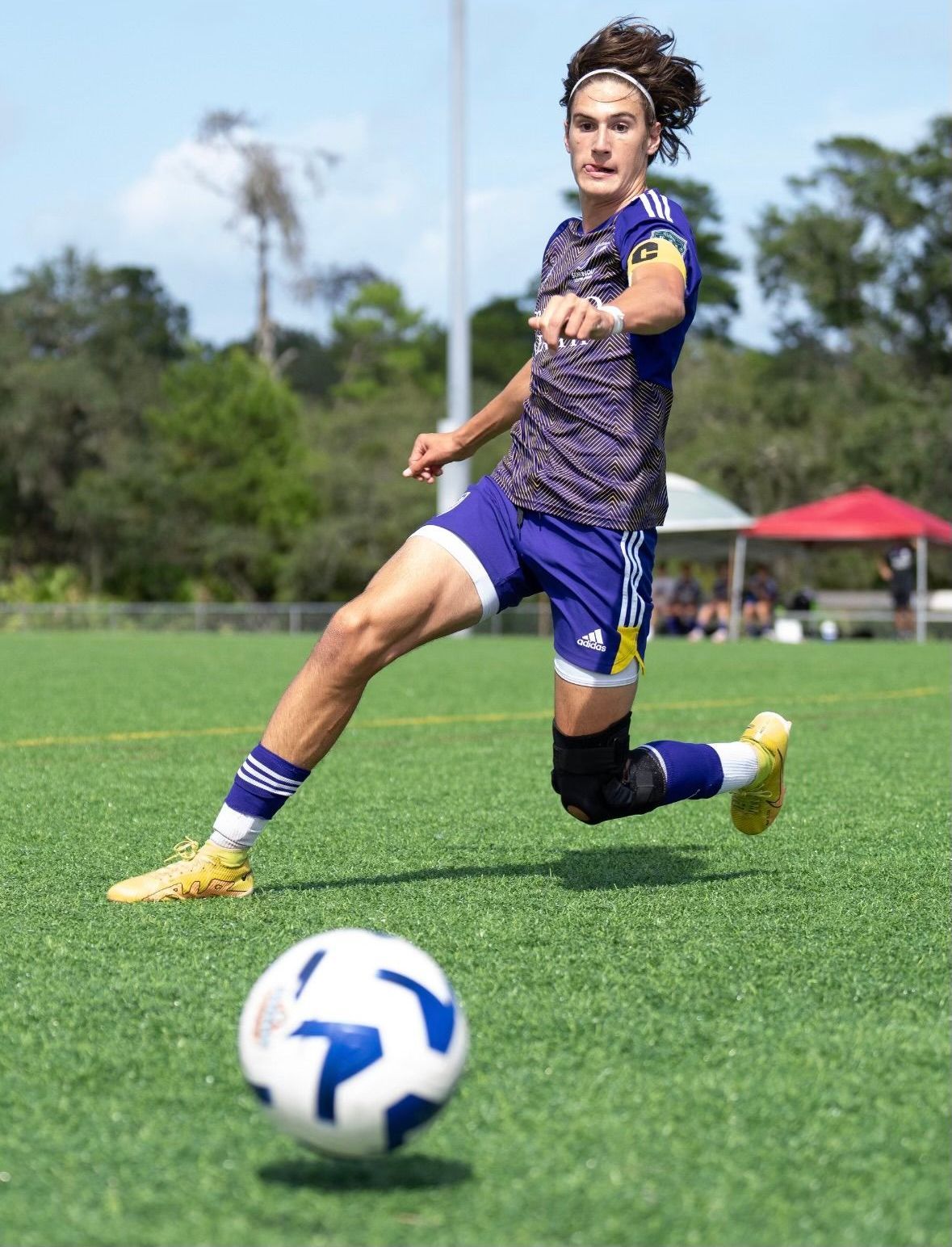 a players sliding for the soccer ball