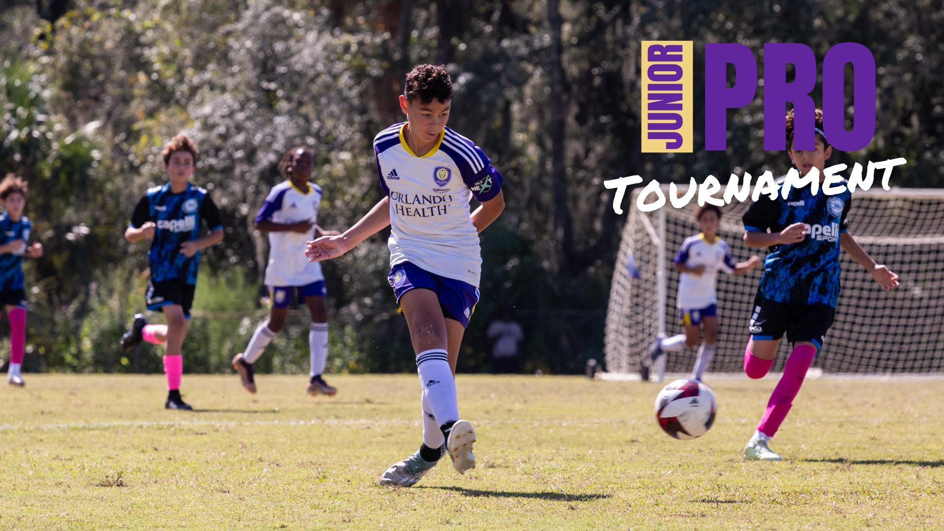 Junior Boy Kicking a Soccer Ball During a Game