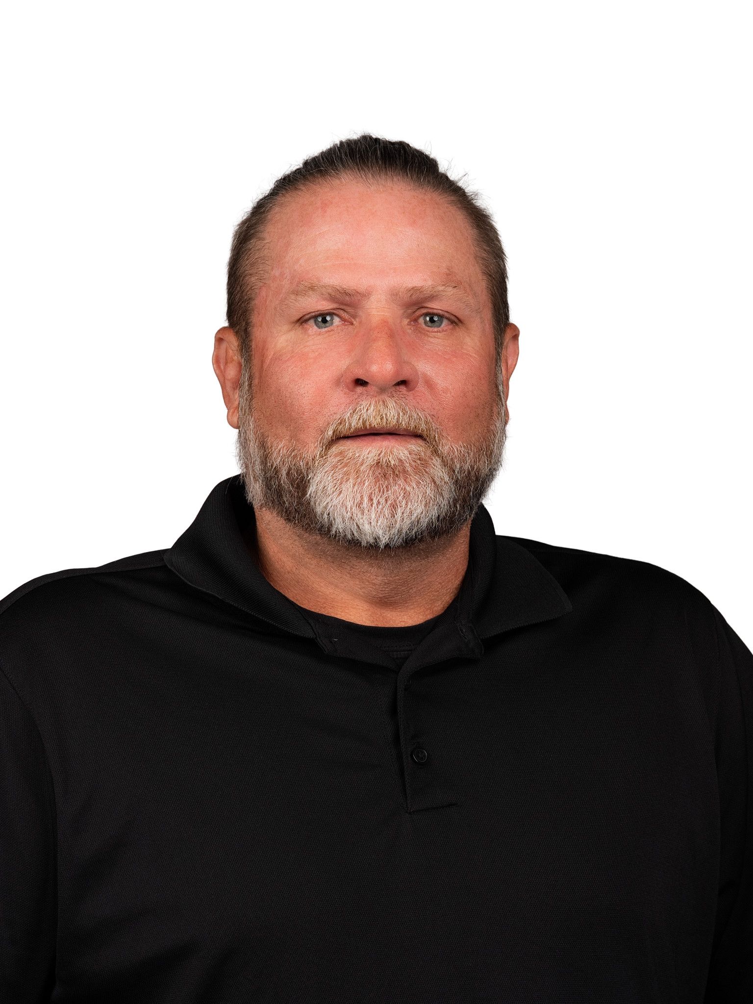 A headshot of someone called Robbie Gobble. He is standing against a purple wall