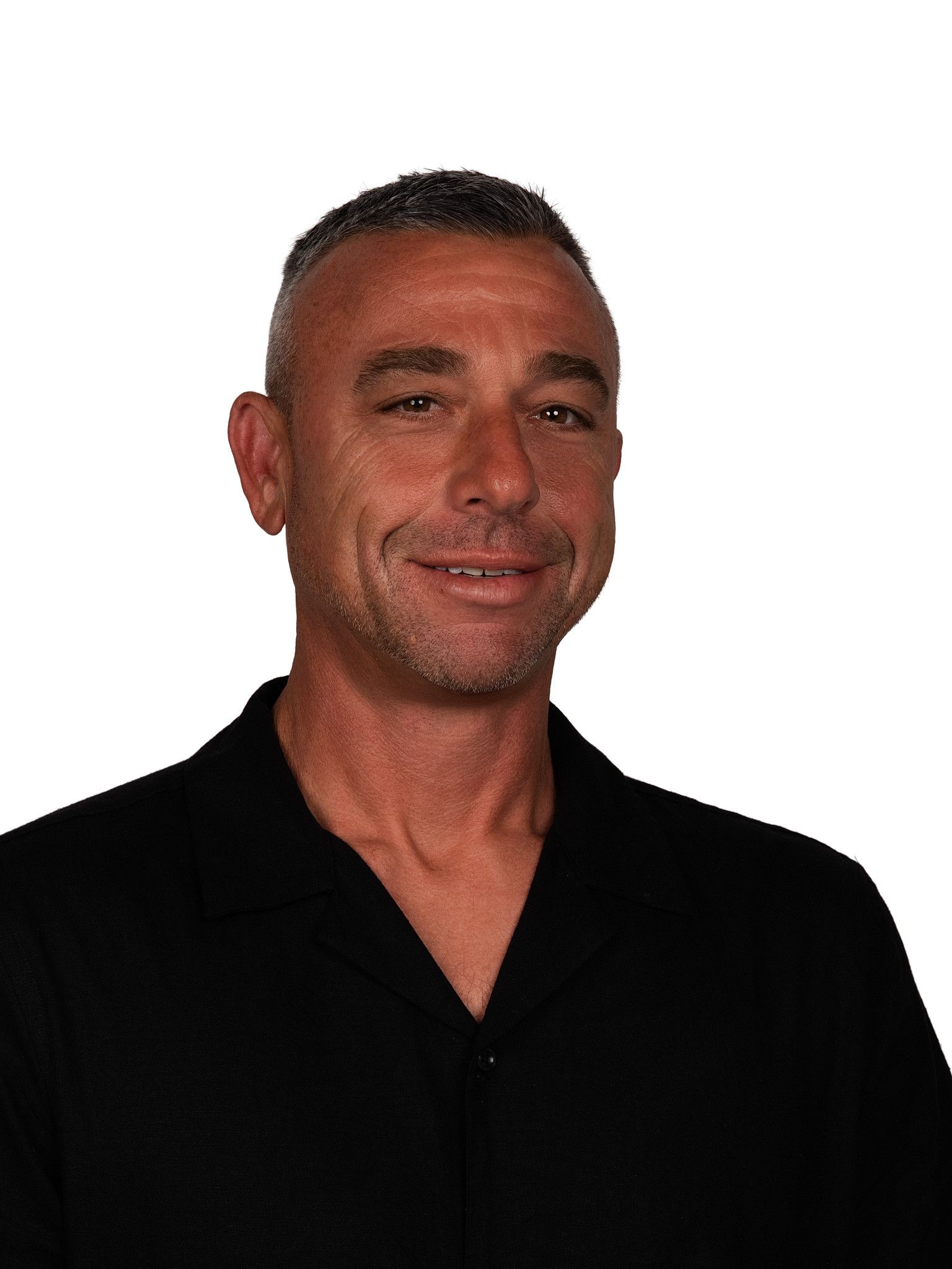 A headshot of someone called Stephen Harrison. He is standing against a purple wall