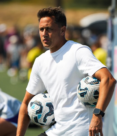 A headshot of someone called Robbie Gobble. He is standing against a purple wall