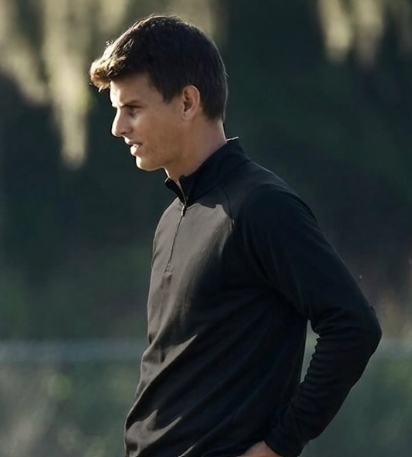 A headshot of someone called Petrut Bambanac. He is standing against a purple wall