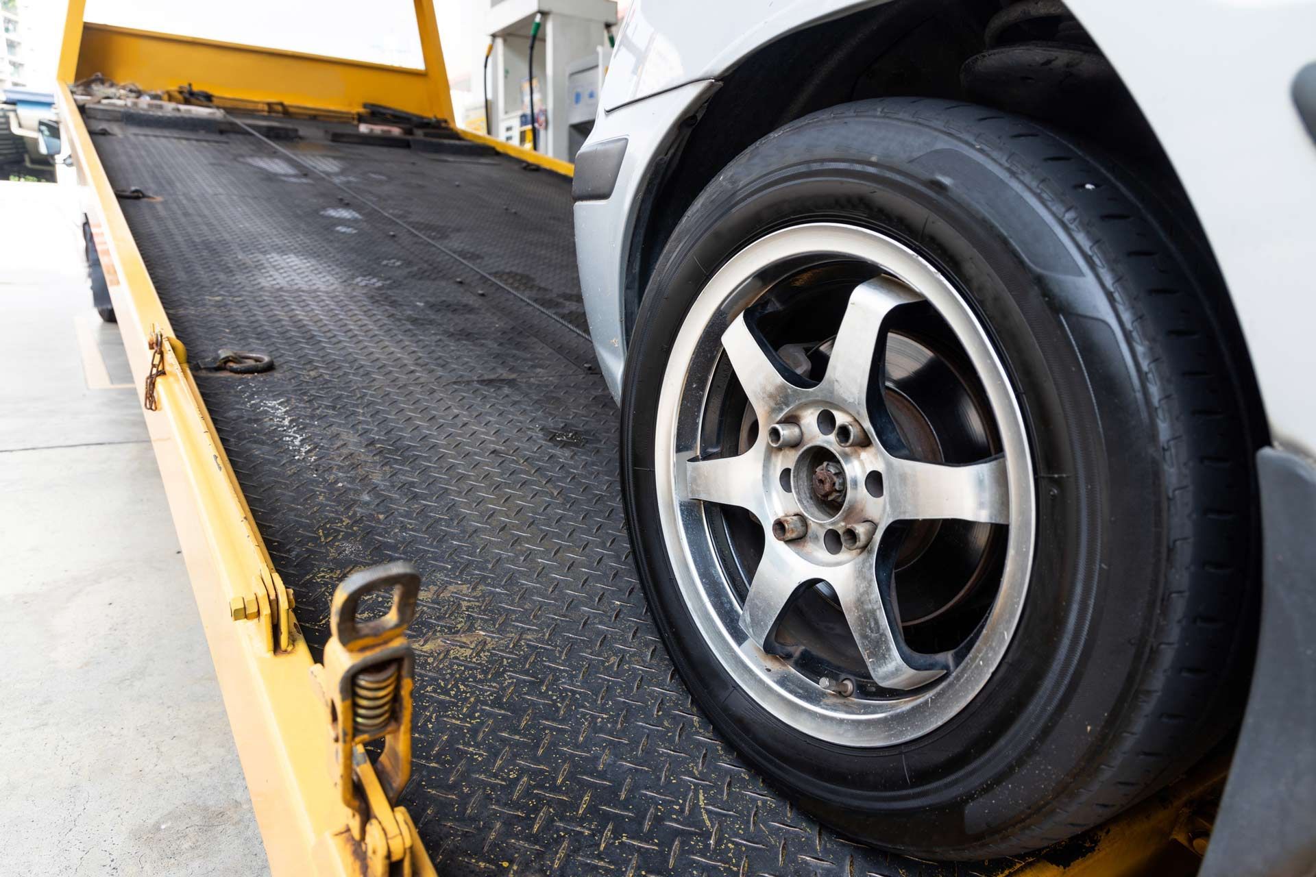 A car is being towed by a tow truck.