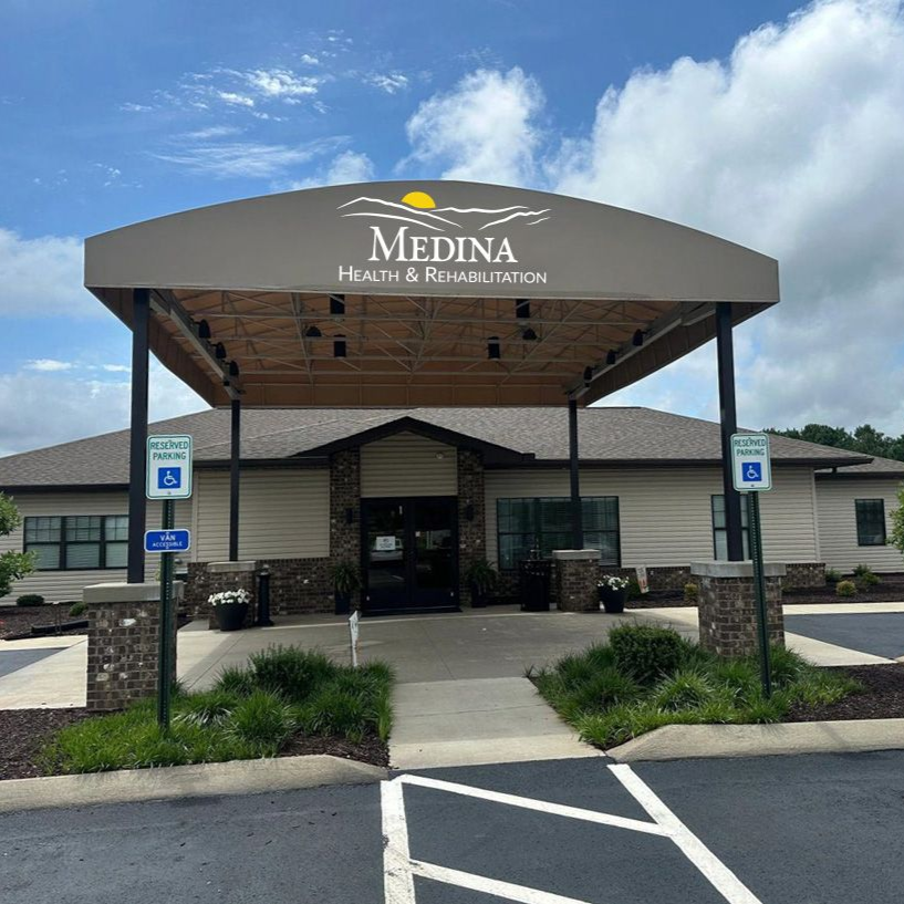 Entrance to Medina Health & Rehabilitation center, beige canopy, brown stonework columns, accessible parking.